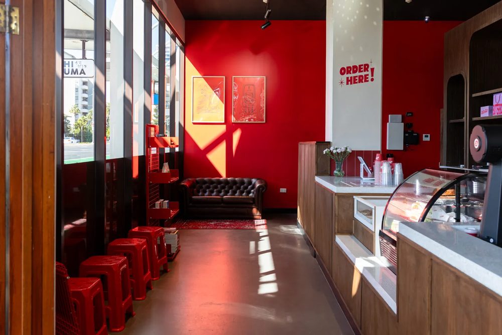 Inside Ace's Coffee — red walls and retro seating
