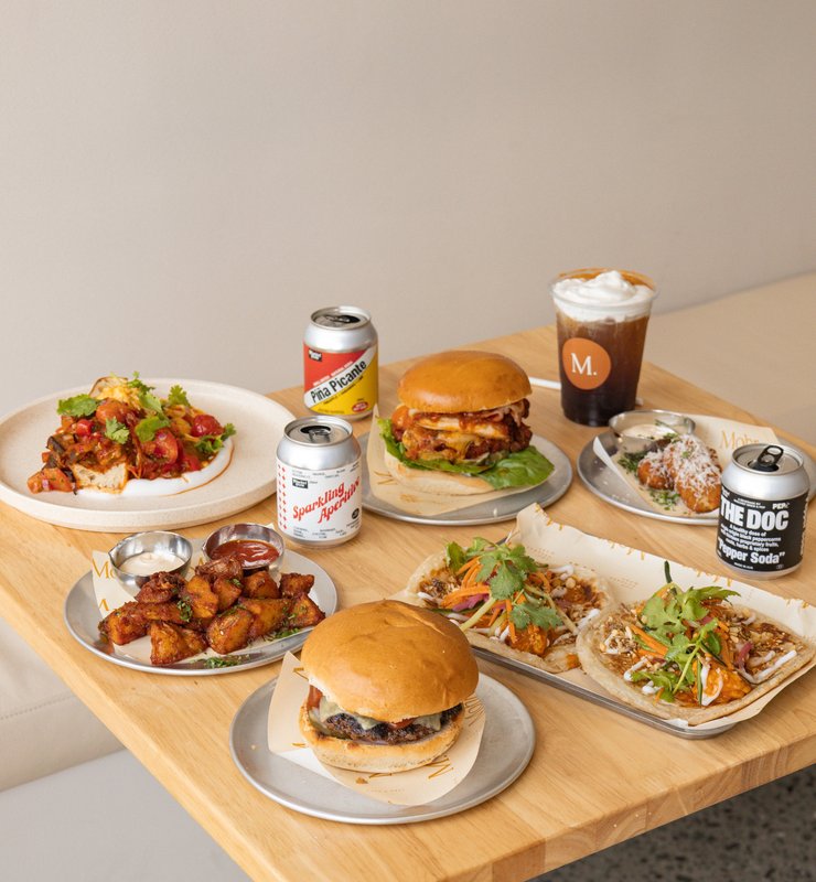 A table of burgers, flatbreads and sides at Mohr Cafe & Deli